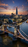 Fototapeta Londyn - Beautiful aerial view of the illuminated Tower Bridge and skyline of London, UK, just after sunset