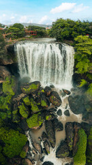 Wall Mural - Aerial view of Thac Voi - Elephant waterfall, forest and city scene near Dalat city and Linh An pagoda in Vietnam