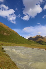 Wall Mural - Ak-Suu river wading on fifth stage of Ak-Suu Traverse trek in Tian Shan mountains, Karakol, Kyrgyzstan