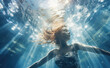 A young woman dives underwater