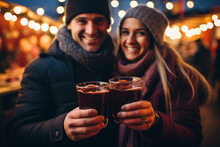 young couple drinking Mulled wine in the christmas market