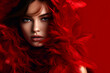Fashion editorial Concept. Closeup portrait of stunning pretty woman with chiseled features, surround in maroon red soft feathers boa. illuminated dynamic composition dramatic lighting. copy space	
