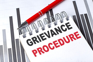 Poster - GRIEVANCE PROCEDURE text written on notebook with pen on chart