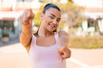 Poster - Young pretty brunette woman points finger at you while smiling