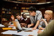 © Marko Geber - Diverse young students studying in college library