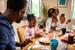 © Marko Geber - Young family having breakfast together in the kitchen in the morning