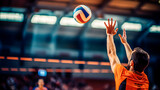 Male volleyball player reaching for ball with hands