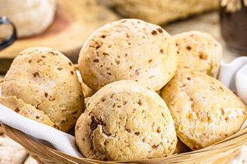 Sticker - bowl full of traditional brazilian cheese bread or cheese biscuit, served crispy and hot, with coffee