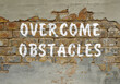 The inscription overcome obstacles on old brickwork