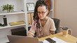 © Krakenimages.com - Focused hispanic business woman, an arm amputee, working diligently on laptop in elegant office