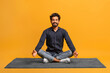 © Prostock-studio - Relaxed young indian man in casual clothes meditating alone, sitting cross-legged on carpe