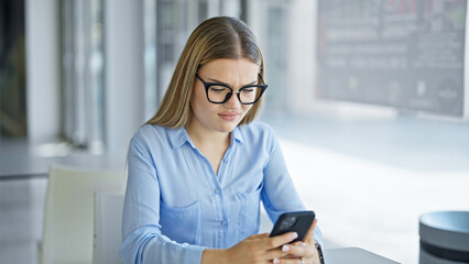 Wall Mural - Young blonde woman business worker using smartphone working at office