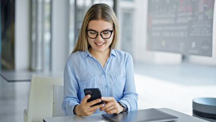 Wall Mural - Young blonde woman business worker using smartphone working at office