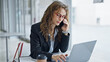© Krakenimages.com - Young woman business worker using laptop talking on smartphone at the office