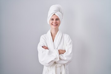 Wall Mural - Blonde caucasian woman wearing bathrobe happy face smiling with crossed arms looking at the camera. positive person.