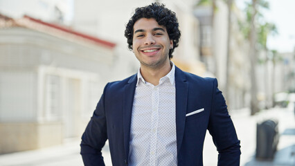 Canvas Print - Young latin man business worker smiling confident standing at street