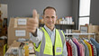 © Krakenimages.com - Confident, smiling middle age man gives thumb up gesture as volunteer at charity center, reflecting the joy of offering community support