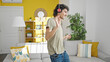 © Krakenimages.com - Young hispanic man listening to music dancing at home