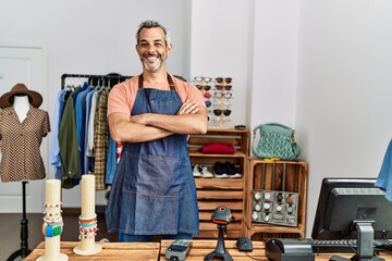 Sticker - Middle age grey-haired man shop assistant standing with arms crossed gesture at clothing store