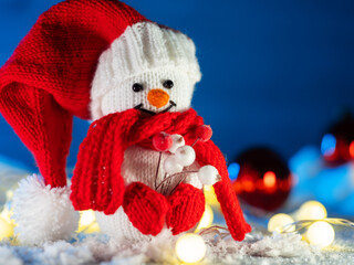 Wall Mural - Christmas card with a happy knitted snowman toy