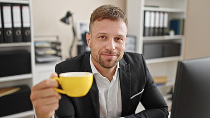 Canvas Print - Young man business worker drinking coffee smiling at office