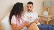 © Krakenimages.com - Man and woman couple sitting on bed drinking coffee at bedroom