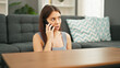 © Krakenimages.com - Young beautiful hispanic woman speaking on the phone sitting on floor at home