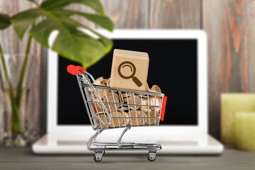 Wall Mural - Shopping cart with cube of Magnifying icon