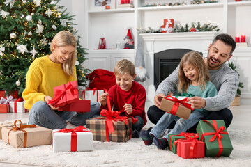 Wall Mural - Happy family with Christmas gifts at home