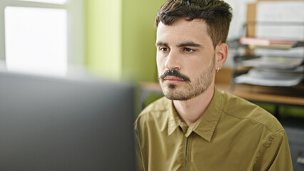 Sticker - Young hispanic man business worker using computer working at office