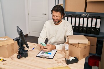 Canvas Print - Middle age man ecommerce business worker using smartphone at office