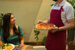 © AntonioDiaz - Host baking pizza for his guest friends in the backyard