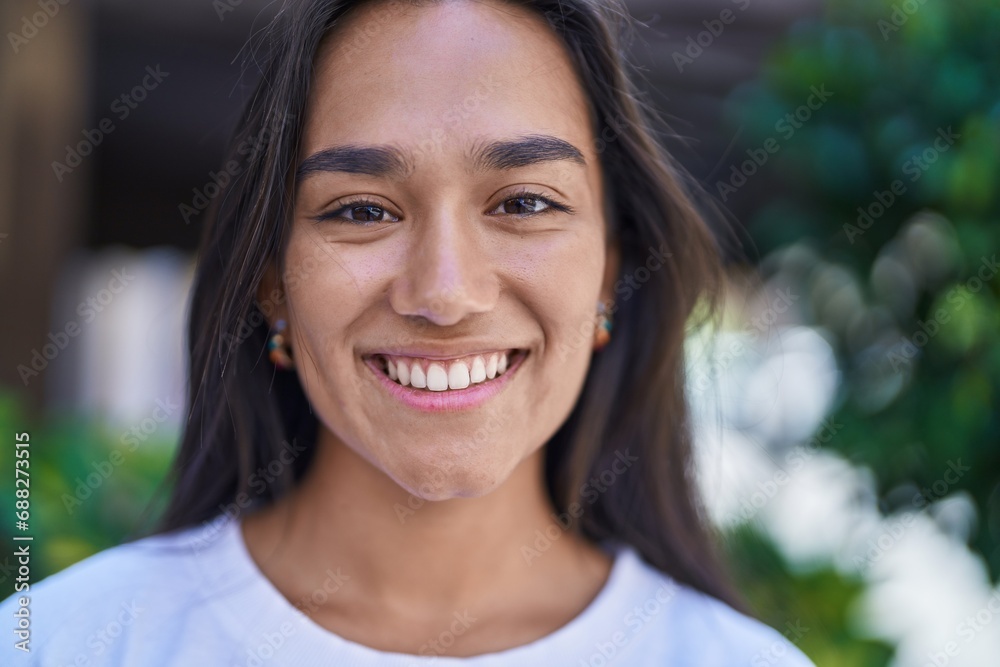 Young beautiful hispanic woman smiling confident standing at street