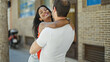 © Krakenimages.com - Beautiful couple smiling confident hugging each other at street