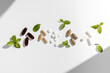 Various vitamins, tablets and dietary supplements with natural formulations on a white background.