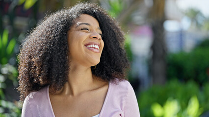 African american woman smiling confident looking to the side at park