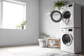 Wall Mural - Interior of modern laundry room with washing machines and grey bench