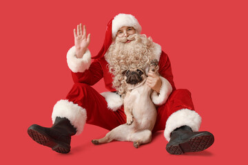 Wall Mural - Santa Claus with French bulldog on red background