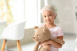 © Pixel-Shot - Little Asian girl after chemotherapy with toy bear in clinic