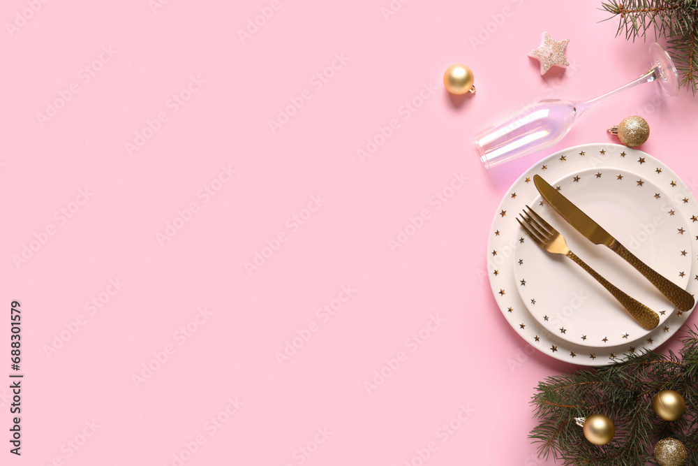 Beautiful table setting with Christmas balls and fir branches on pink background