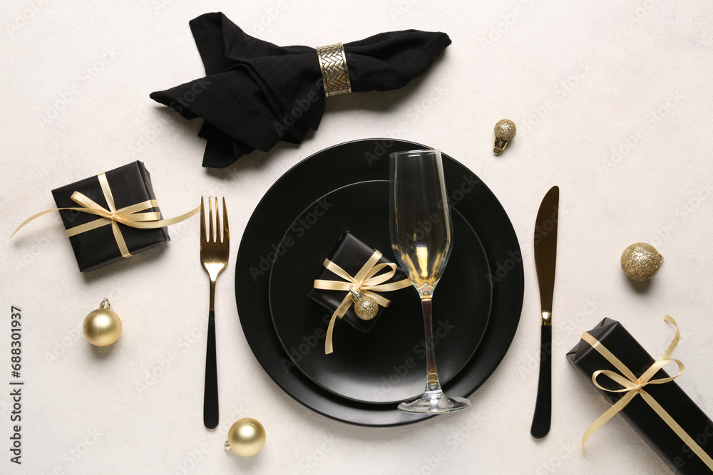 Beautiful table setting with Christmas balls and gift boxes on white background
