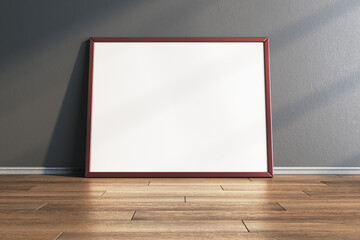 Poster - Empty white photo frames leaning on gray concrete wall in interior with wooden flooring. Mock up, 3D Rendering.