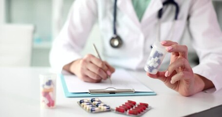 Wall Mural - The doctor holds the medicine and writes a prescription, close-up. Medical prete treatment, slowmotion