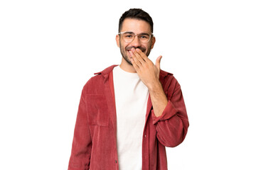 Wall Mural - Young handsome caucasian man over isolated chroma key background happy and smiling covering mouth with hand