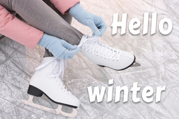 Wall Mural - Hello winter. Woman lacing figure skates on ice, closeup