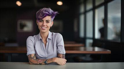 young happy artist woman with short purple hair and a tattoo looking at the camera standing inside a working place