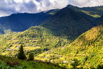 Wall Mural - travel to Georgia - rainy clouds over overgrown mountains in Machakhela national park in Adjara on sunny autumn day