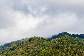 Wall Mural - travel to georgia - gray clouds on mountains tops in machakhela national park in adjara on autumn da