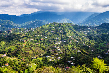 Poster - travel to Georgia - view of mountains slopes near Batumi city from Sameba hill on sunny autumn day