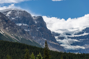 View of Mt Kitchener and the Stutfield Glacier in Jasper National Park, AB, Canada both located in the Columbia Icefield with a white clouded blue sky